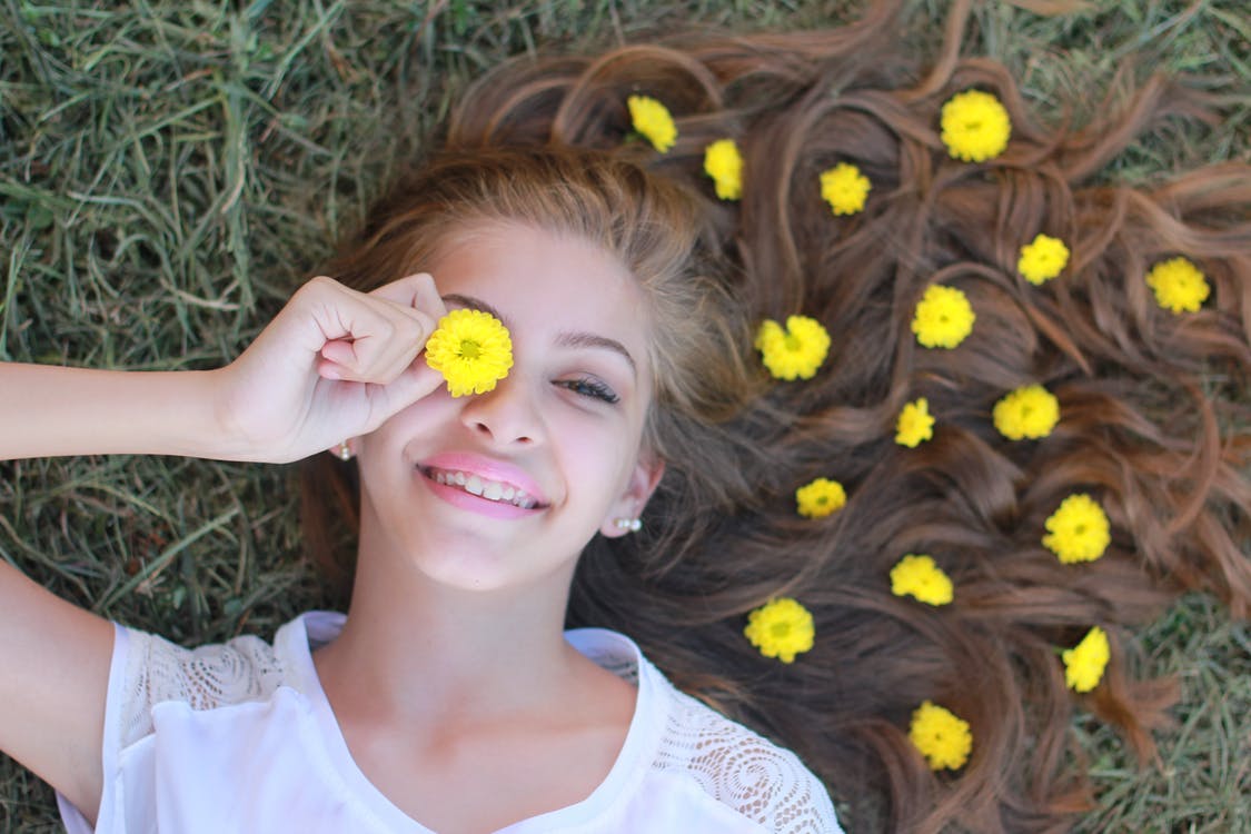 Smiling girl with flower