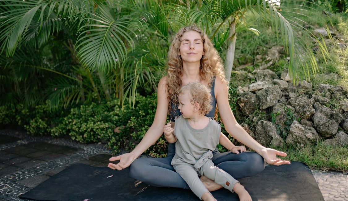 Mom meditating with kid